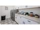 A modern laundry room with white cabinets, countertops and a sleek washer and dryer at 28265 N 158Th St, Scottsdale, AZ 85262