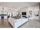 An open-concept living room with a modern fireplace, white sectional, and butler's pantry at 28265 N 158Th St, Scottsdale, AZ 85262