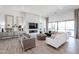 A bright living room features a modern fireplace, comfortable seating, and large windows at 28265 N 158Th St, Scottsdale, AZ 85262