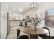 Elegant kitchen featuring white cabinetry, stainless steel appliances, and a cozy breakfast nook at 3027 N 83Rd Pl, Scottsdale, AZ 85251