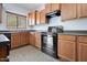 A functional kitchen with ample wood cabinetry, modern appliances, and sleek countertops at 3794 S Laurel Way, Chandler, AZ 85286