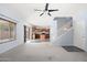 View of the living room featuring carpet, stairs, a ceiling fan and a sliding glass door to the back at 3794 S Laurel Way, Chandler, AZ 85286