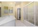 Light-filled bathroom featuring a vanity and a tub-shower combo with sliding glass doors at 4202 E Broadway Rd # 93, Mesa, AZ 85206