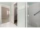 Bright bathroom featuring a walk-in shower, tiled floors, and access to bedroom and walk-in closet at 4202 E Broadway Rd # 93, Mesa, AZ 85206