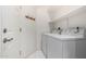 Convenient laundry room with washer, dryer, shelving, and a door at 4202 E Broadway Rd # 93, Mesa, AZ 85206