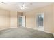 Spacious main bedroom featuring neutral walls, ceiling fan, carpet, and access to an ensuite bathroom at 4202 E Broadway Rd # 93, Mesa, AZ 85206