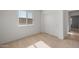 Bedroom featuring neutral carpet, ample natural light from the window, and a closet at 42845 W Vincent Dr, Maricopa, AZ 85138