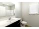 Bathroom features vanity with sink, a large mirror, and a walk-in shower at 42890 W Peters Dr, Maricopa, AZ 85138