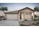 Charming single-story home with a two-car garage and desert landscaping at 42890 W Peters Dr, Maricopa, AZ 85138
