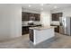 Bright kitchen with stainless steel appliances and a granite island at 42890 W Peters Dr, Maricopa, AZ 85138
