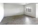 Bright living room featuring tile flooring and a window at 42890 W Peters Dr, Maricopa, AZ 85138