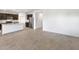 Open-concept living area with tile flooring, adjacent to a modern kitchen at 42890 W Peters Dr, Maricopa, AZ 85138