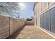 Image showcasing the backyard, featuring a block wall, gravel, and minimal greenery at 433 E Utopia Rd, Phoenix, AZ 85024