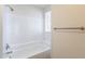 A clean, all white bathroom features a tub and shower at 433 E Utopia Rd, Phoenix, AZ 85024