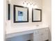 A well lit bathroom vanity features two mirrors, cabinets and counter space at 433 E Utopia Rd, Phoenix, AZ 85024