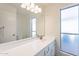 Clean, bright bathroom with a large mirror, vanity with cabinets, and a frosted window at 433 E Utopia Rd, Phoenix, AZ 85024