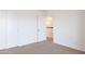 Well-lit bedroom featuring carpeted floors and a closet, offering ample storage at 433 E Utopia Rd, Phoenix, AZ 85024