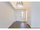 Inviting entryway with a bright light fixture, white walls, and hardwood floors at 433 E Utopia Rd, Phoenix, AZ 85024