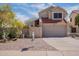 Charming two-story home featuring a red tile roof and a well-maintained front yard at 433 E Utopia Rd, Phoenix, AZ 85024