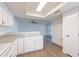 Bright kitchen with white cabinets, stone countertops, and modern appliances leading into the living area at 433 E Utopia Rd, Phoenix, AZ 85024