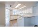 Bright kitchen featuring white cabinets, stone countertops, and modern appliances with bar seating at 433 E Utopia Rd, Phoenix, AZ 85024