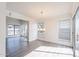 Bright and airy living room featuring wood floors, large windows, and modern lighting fixture at 433 E Utopia Rd, Phoenix, AZ 85024
