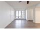 Bright living room featuring wood floors, large windows, and access to other rooms in the unit at 433 E Utopia Rd, Phoenix, AZ 85024