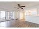 Bright living room featuring wood floors, a ceiling fan, and access to the kitchen at 433 E Utopia Rd, Phoenix, AZ 85024