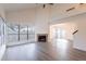 Spacious living room with large windows, vaulted ceilings, a cozy fireplace, and hardwood flooring at 433 E Utopia Rd, Phoenix, AZ 85024