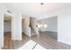 Bright living room showing wood floors, a modern light fixture, and access to the upstairs and other rooms at 433 E Utopia Rd, Phoenix, AZ 85024