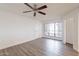 A well lit living room features a ceiling fan, sleek floors and a large window at 433 E Utopia Rd, Phoenix, AZ 85024