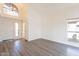 Open living area with vaulted ceiling, hardwood floors, large windows, and a modern chandelier at 433 E Utopia Rd, Phoenix, AZ 85024