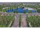 A beautiful aerial view of the community lake, pool, and surrounding homes at 44196 W Askew Dr, Maricopa, AZ 85138