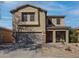 Charming two-story home featuring a well-maintained yard, two-car garage and welcoming front porch at 44196 W Askew Dr, Maricopa, AZ 85138