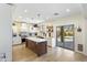 Spacious kitchen with white cabinetry, stainless steel appliances, island and sliding door to the backyard at 44196 W Askew Dr, Maricopa, AZ 85138