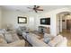 Comfortable living room featuring neutral furniture, a ceiling fan, and large-screen television at 44196 W Askew Dr, Maricopa, AZ 85138