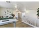Bright living room with white walls, hardwood floors, and staircase with white railing at 44196 W Askew Dr, Maricopa, AZ 85138