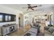 Open-concept living area showcases wood flooring, a ceiling fan, and a seamless flow to the kitchen at 44196 W Askew Dr, Maricopa, AZ 85138
