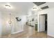 Bright living room with white walls, hardwood floors, and white staircase at 44196 W Askew Dr, Maricopa, AZ 85138