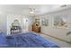 Bright main bedroom with en suite bath, windows, and a dresser at 44196 W Askew Dr, Maricopa, AZ 85138