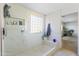 White tiled shower with glass block window, and bench at 44196 W Askew Dr, Maricopa, AZ 85138
