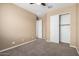 Bedroom featuring carpet, a ceiling fan, closet, and open door to another room at 4960 S Wade Dr, Gilbert, AZ 85298