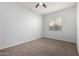 Simple bedroom with neutral walls, carpet, a ceiling fan, and natural light at 4960 S Wade Dr, Gilbert, AZ 85298