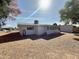 Exterior home view of the spacious backyard with easy care landscaping and an outdoor shed at 5828 E Dallas St, Mesa, AZ 85205