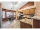 Well-lit kitchen with stainless steel appliances, granite counters, and cozy dining area at 7515 W Jenan Dr, Peoria, AZ 85345