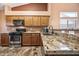 Kitchen featuring granite countertops, stainless steel appliances and tile flooring at 7515 W Jenan Dr, Peoria, AZ 85345