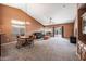 Spacious living room featuring vaulted ceiling, large windows, and sliding glass door at 7515 W Jenan Dr, Peoria, AZ 85345