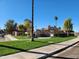 Well-maintained community featuring lush green spaces and mature palm trees at 7977 W Wacker Rd # 171, Peoria, AZ 85381
