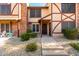 Charming two-story townhome with a walkway lined with decorative rocks and healthy green bushes at 7977 W Wacker Rd # 171, Peoria, AZ 85381