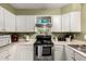 Functional kitchen with white cabinets, stainless steel appliances, and ample countertop space at 7977 W Wacker Rd # 171, Peoria, AZ 85381